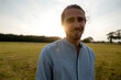 © KNSY/Westend61 - Portrait of a happy young man on a meadow in the countryside at sunset
