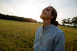 © KNSY/Westend61 - Content young man on a meadow in the countryside looking up