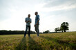 © KNSY/Westend61 - Father and adult son standing on a meadow in the countryside