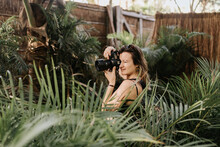 Female Photographer Photographing Palm Trees