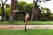 © Manu Reyes, www.vientocuatro.com/Westend61 - Shirtless male athlete practicing acroyoga on bench at park