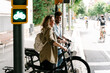 © @diferentroger/Westend61 - Smiling young couple with electric bicycles standing on sidewalk