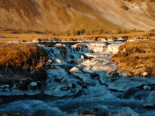 Wall Mural - Iceland's breathtaking mountain landscape in winter, a river with a waterfall. Nature paints