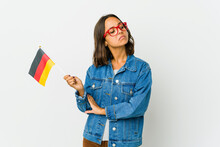 Young Latin Woman Holding A German Flag Isolated On White Background