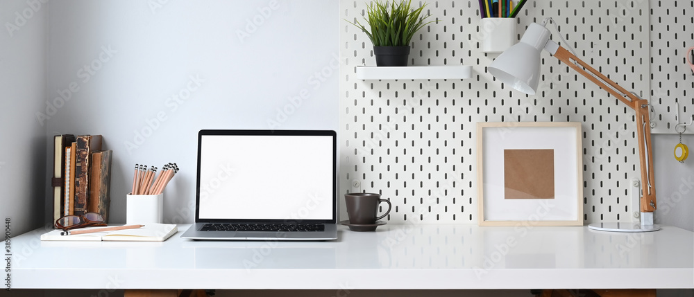 Mockup blank screen laptop and office supplies on white desk. - obrazy, fototapety, plakaty 