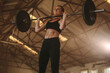 © Jacob Lund - Tough woman doing snatch workout with barbell