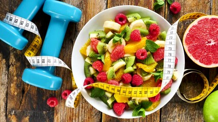 Wall Mural - diet food concept-healthy fruit salad with dumbbell and meter