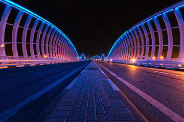 A night view of Meydan Bridge with blue lights