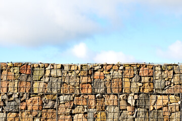 Wall Mural - Behind the stone fence, the sky is blue. Freedom behind the fence. Copy space.