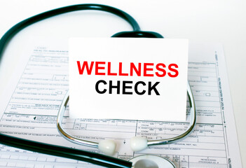 Text Wellness Check on the white card with the stethoscope and medical documents