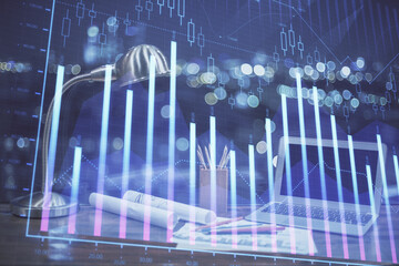 Stock market chart hologram drawn on personal computer background. Double exposure. Concept of investment.