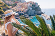 girl in stylish clothes and sunglasses admire the view and palm