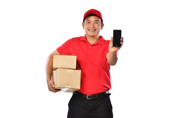 Asian delivery man in red uniform with parcel cardboard box showing mobile phone isolated on white background