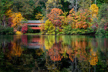 With A Beautiful Reflection On Lake Loretta In Alley Park, Lancaster, Ohio, The Red George Hutchins Covered Bridge, Surrounded By Colorful Autumn Leaves, Was Constructed In 1865 At Another Location.