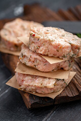 Wall Mural - Fresh raw minced chicken cutlets with spices and seasonings on a wooden Board