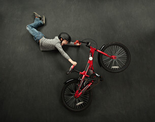 Lay flat picture of boy doing a bike trick