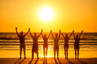 © yurakrasil - six health people in stand hatha position with hand up raced and breath full chest in Goa India beach at sunset