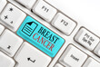 Word writing text Breast Cancer. Business photo showcasing disease in which cells in the breast grow out of control Different colored keyboard key with accessories arranged on empty copy space