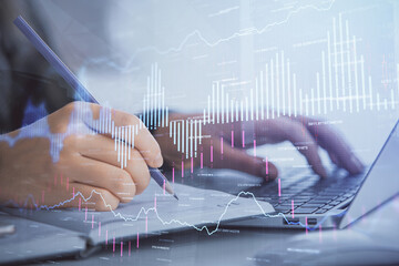 Double exposure of businesswoman hands typing on computer and forex chart hologram drawing. Financial analysis concept.