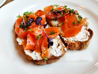 Wall Mural - Bruschetta with lightly salted salmon and buttercream are on a plate.