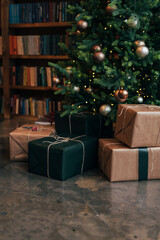 many beautiful Christmas presents lie under the tree on the floor. craft gift wrapping. winter holidays. Christmas mood
