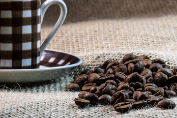 cup of coffee and grain coffee beans on jute background in Brazil