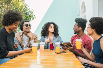 Wall Mural - Afro friends having fun together while drinking fruit juice.