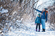 © zhukovvvlad - Woman with a child on a winter hike in the mountains.