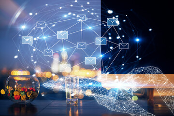 Desktop computer background in office and flying envelops hologram drawing. Double exposure. Electronic mail concept.