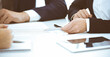 © rogerphoto - Group of business people and lawyers discussing contract while sitting at the table in office, close-up. Successful teamwork, cooperation and agreement concepts
