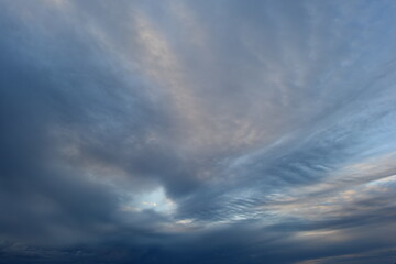 Wall Mural - Twilight light of a skylight in dark blue clouds sky