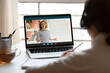 © fizkes - Rear view close up woman wearing headphones watching webinar, studying online, distance learning foreign language, video call, writing notes, tutor mentor teaching, explaining, making presentation