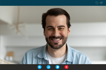 Head shot portrait device screen view smiling man chatting with friends or relatives online, looking at camera, overjoyed young male using webcam and social media app, engaged internet conference