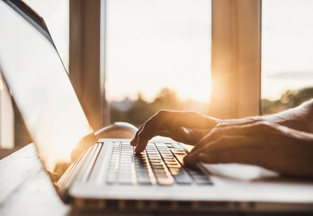 Male hands typing on computer keyboard closeup, business man or student using laptop at home, online learning, internet marketing, working from home, office workplace, freelance concept