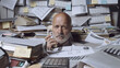 © stokkete - Stressed businessman under a lot of paperwork