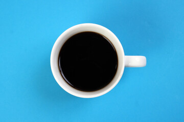 Black coffee cup on blue white background top view copy text space