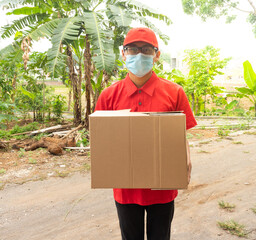 Asian young man delivery in red uniform with packages