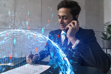 A man in office signing papers while talking mobile and social media hologram. Double exposure. Formal wear.