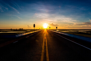 Beautiful sun rising sky with asphalt highways road in rural scene