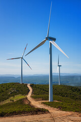 Wall Mural - wind turbines on a beautiful blue sky in a mountain wind farm in sardinia. renewable energy concept,