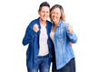 © Krakenimages.com - Couple of women wearing casual clothes very happy and excited doing winner gesture with arms raised, smiling and screaming for success. celebration concept.