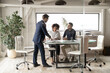 © fizkes - Full length confident young european leader holding negotiation meeting with motivated skilled african american female and arabian ethnicity male colleagues, brainstorming company development ideas.