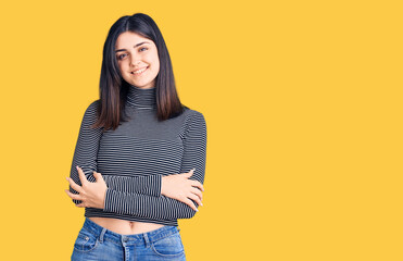 Young beautiful girl wearing striped t shirt happy face smiling with crossed arms looking at the camera. positive person.