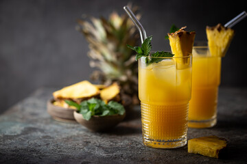 Fresh pineapple cocktail in the glass with ice and mint, summer drink