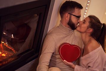 Wall Mural - Adult couple with present over fireplace