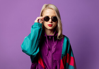 Sticker - Style blonde in 80s windbreaker and roud sunglasses on purple background