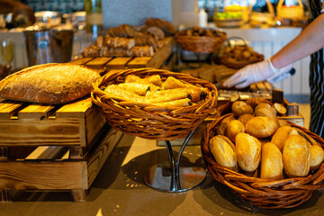 A cutting board with bread on self service table breakfast buffet in hotel catering