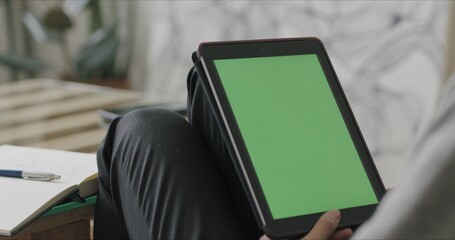 Wall Mural - Woman holding tablet computer with green screen