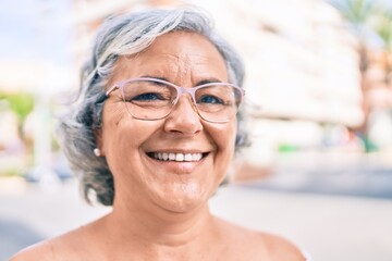 Wall Mural - Middle age woman with grey hair smiling happy outdoors