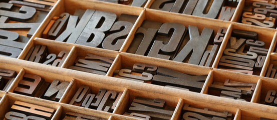 Old letterpess background. Collection of vintage block letters made of wood